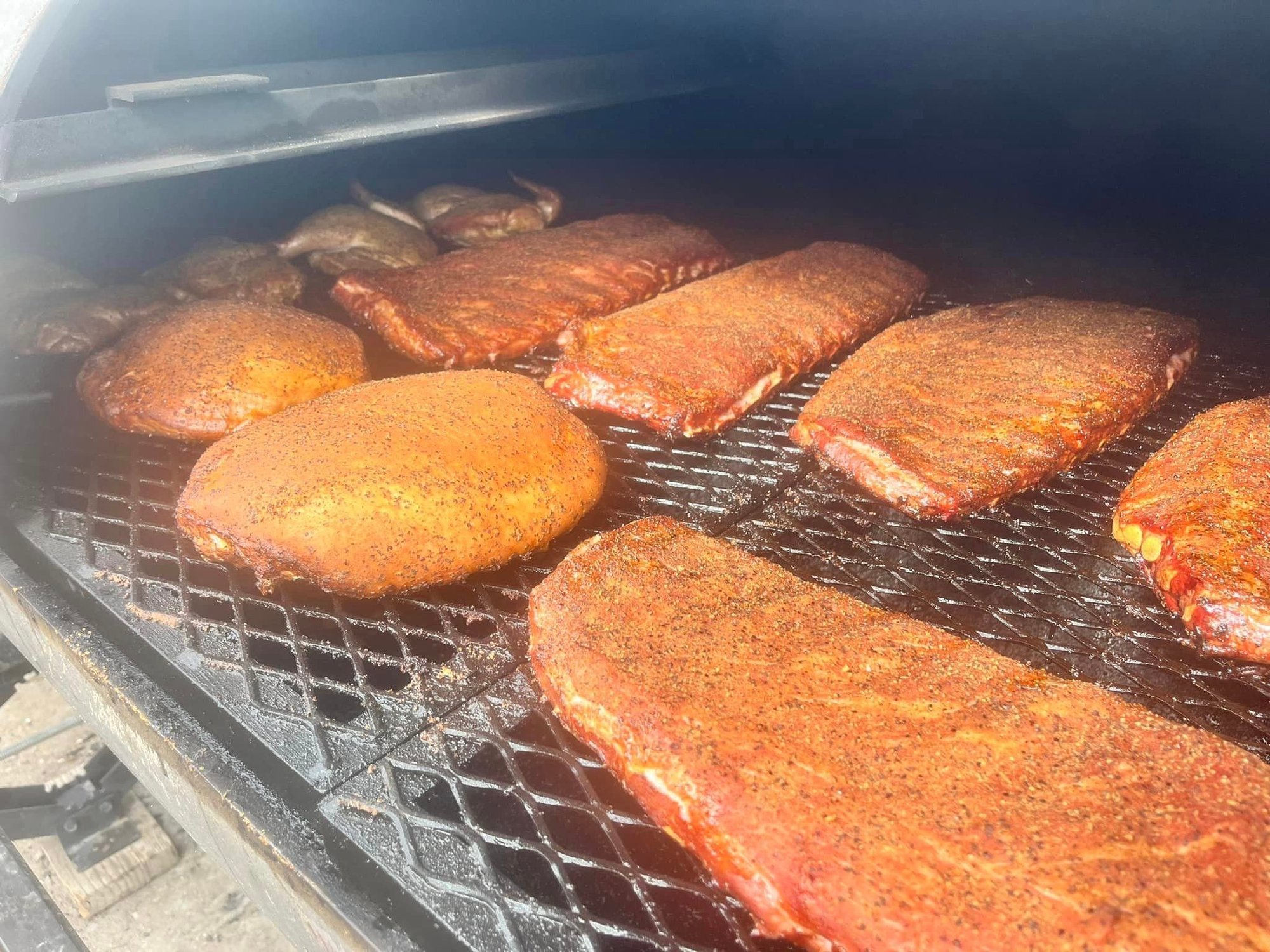 Sliced brisket flat on cutting board, smoke ring and bark detail